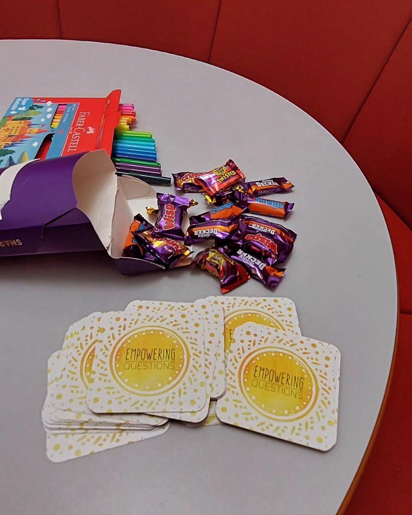 chocolates, felt pens, and empowering cards on a table.