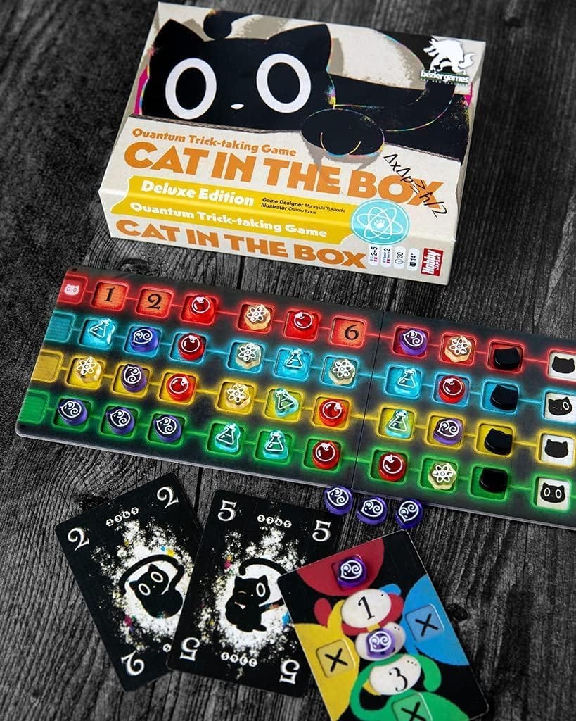 A picture of the “Cat in the Box” board game, with cards and the game board laid out.