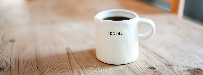 Image of mug of coffee on table by Danielle MacInness Unsplash