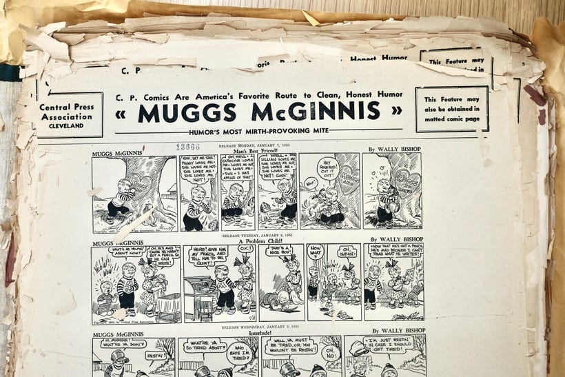 Photo of sheets of tear sheets or promo sheets from the Central Press Association for the comic strip Muggs McGinnis, showing several strips per page. Pages are crumbling paper with edges falling apart.