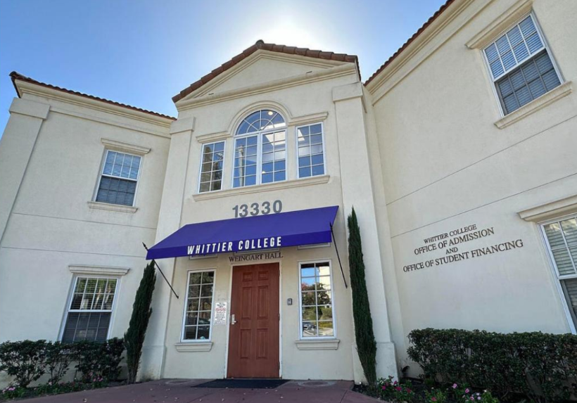 A photo of the Whittier College office of Admission and Office of Student Financing on a bring and sunny day. There is a purple awning over the entrance that reads “Whittier College” in white letters.