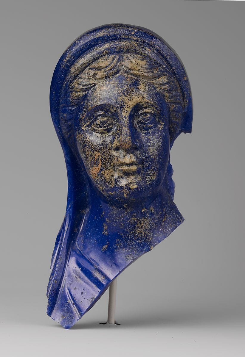 Blue glass head of woman with gold spattering