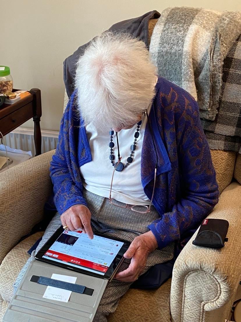 Granny lent over her ipad looking at the Tote website