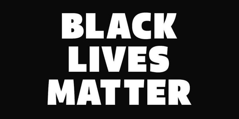 “Black lives matter” written on a black background.