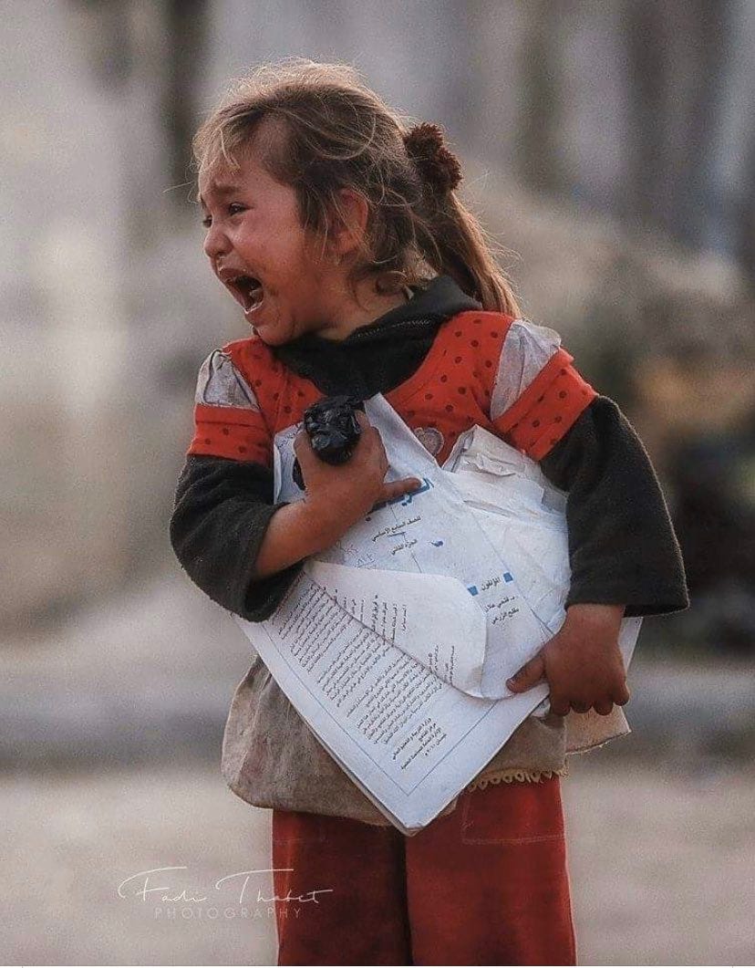 A girl cries her eyes out as Israel bombs her city, Gaza.