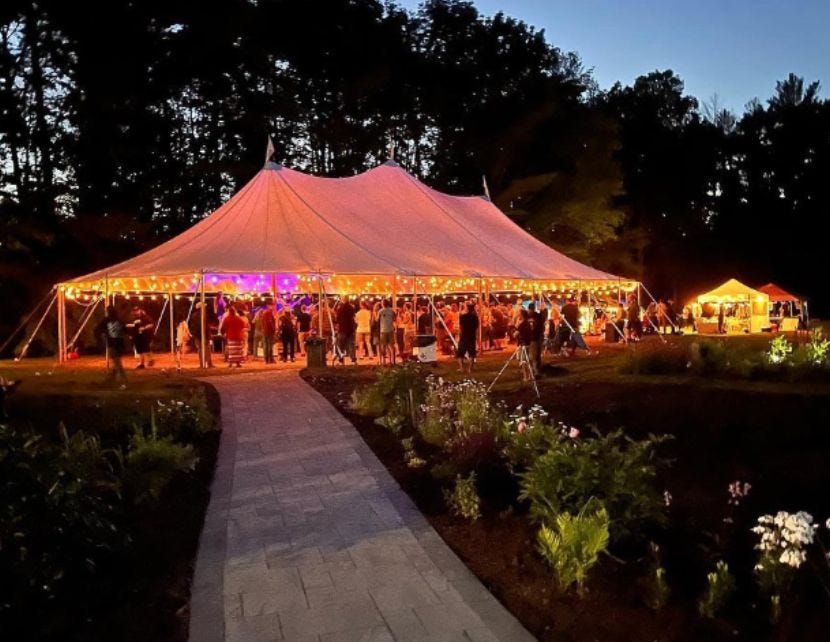 A tent lit up with lights at the Reggae Garden concert series in Maine. Image via Reggae Garden.