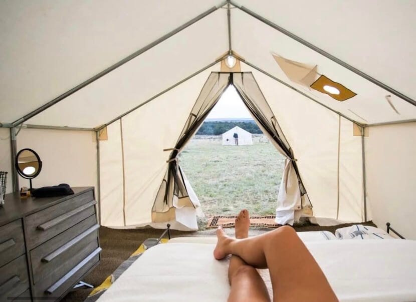 A woman relaxing inside a glamping tent at the New York State Cannabis Festival. Image via the New York State Cannabis Festival.