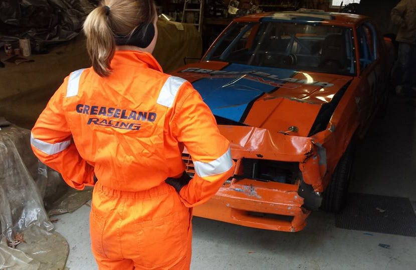 inspecting race car damage