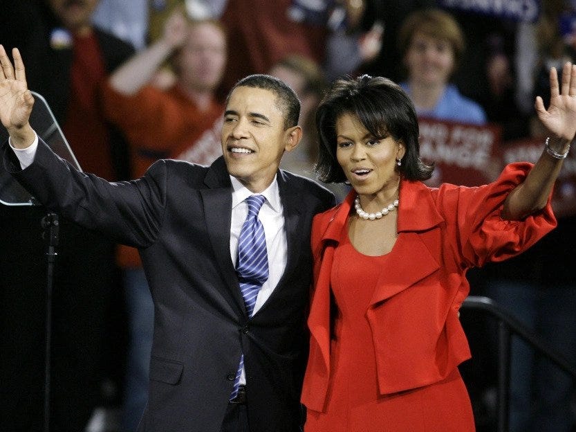 Barack Obama and Michelle Obama waving to their supporters