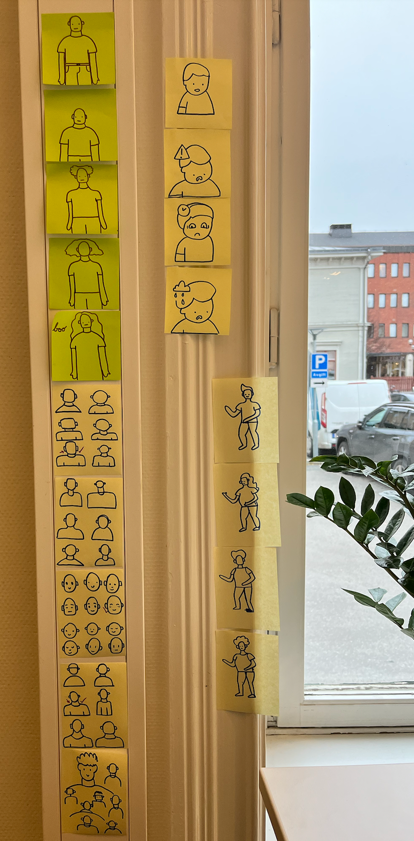 Post-it notes with hand drawn illustrations, sticked on a wall