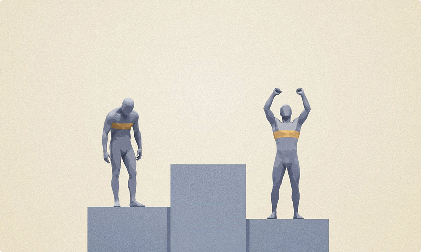 A winners’ podium where the silver medallist, on the higher step, stands with head bowed while the bronze medallist, on the lower step, celebrates with both arms raised.