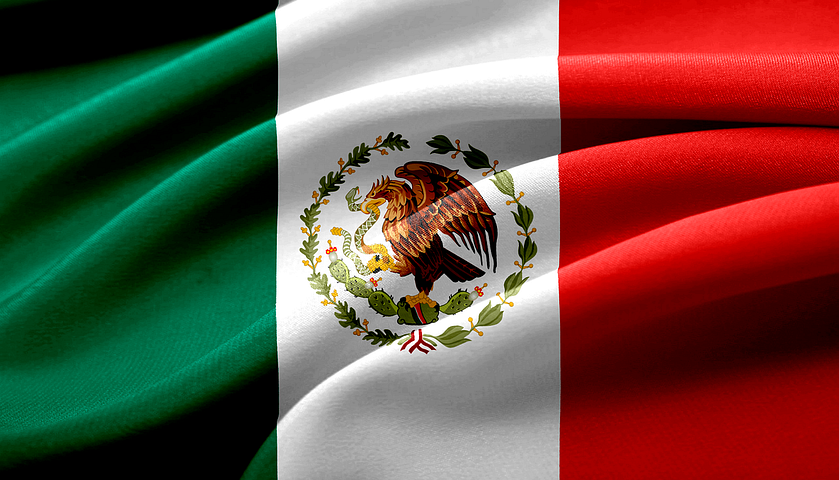 Mexican flag with bands of green, white, and blue with an eagle eating a snake atop a cactus in the center