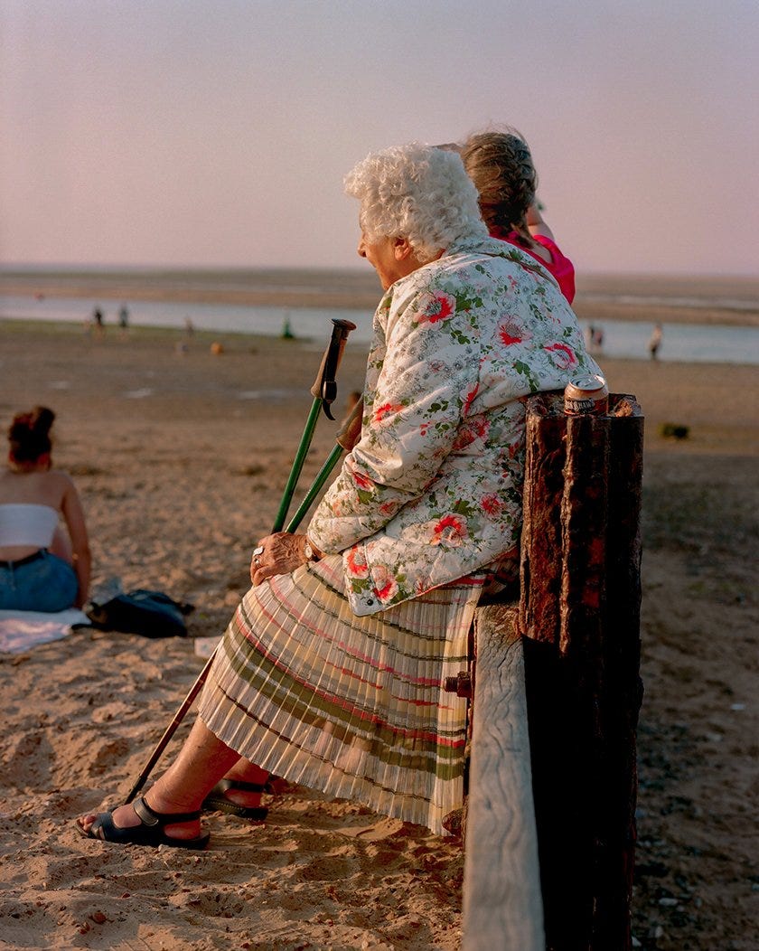 An elderly woman in a floral Jacket rests for a minute in Wells-Next-The-Sea, north Norfolk. This part of the East Coast form