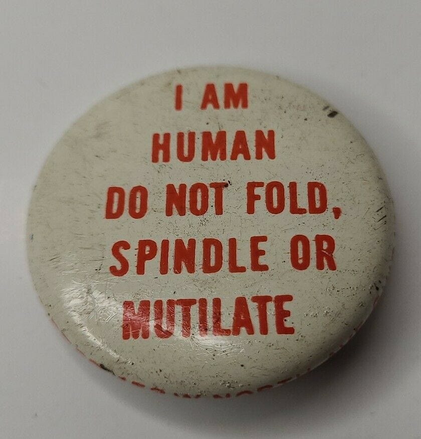 A badge reading “I am human. Do not fold, spindle or mutilate.”