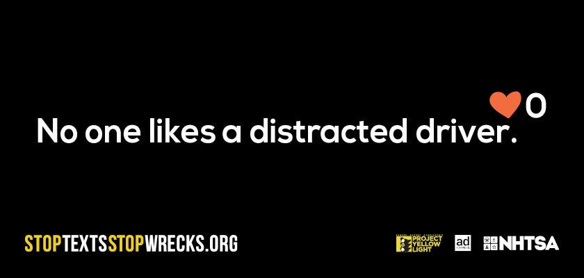 An all-black image has text over it, which reads "No one likes a distracted driver." There's a heart above the text with the number zero next to it.