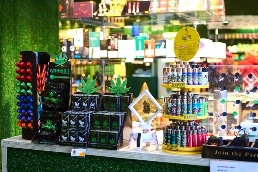 Cannabis products on display in a green room in a dispensary.