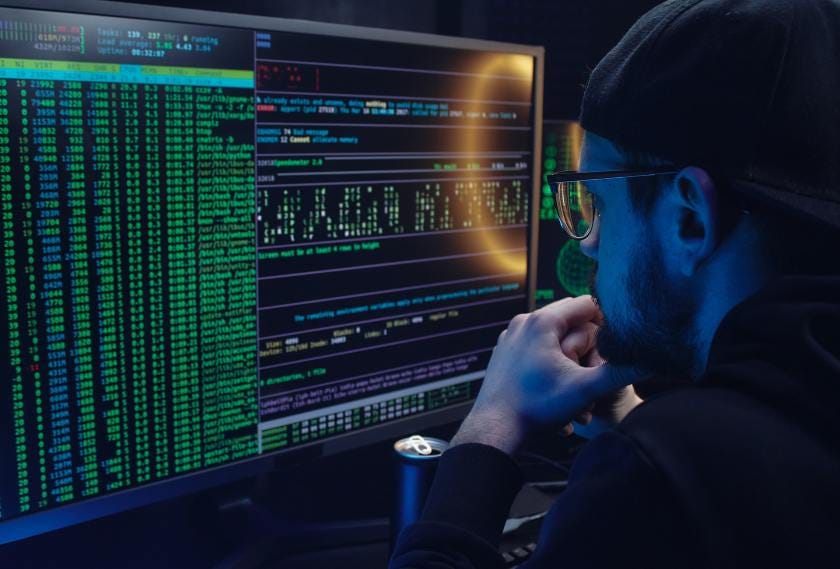 A man looks at data on a computer screen.