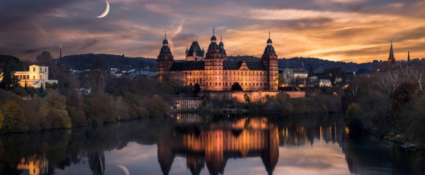 renaissance-castle-johannisburg-reflected-in-water-on-a-moonlit-night