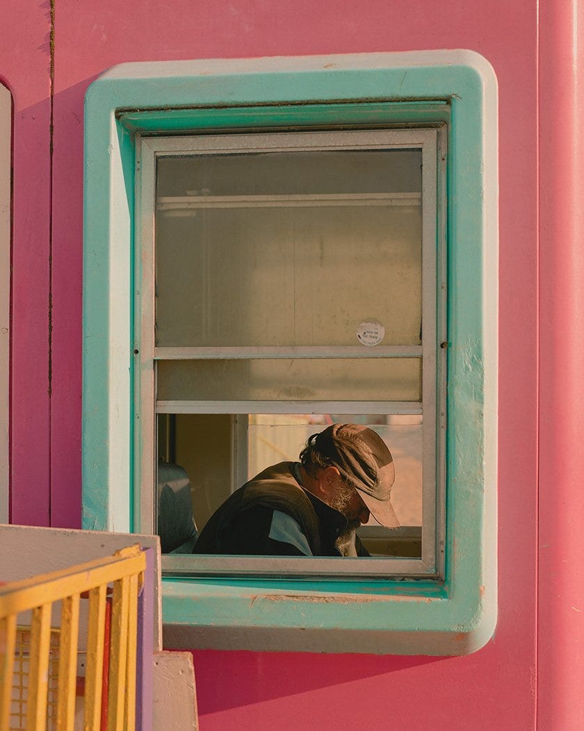 Local attendant Will in the helter-skelter booth. Cleethorpes, Lincolnshire. A region once famed for its quaint British coast