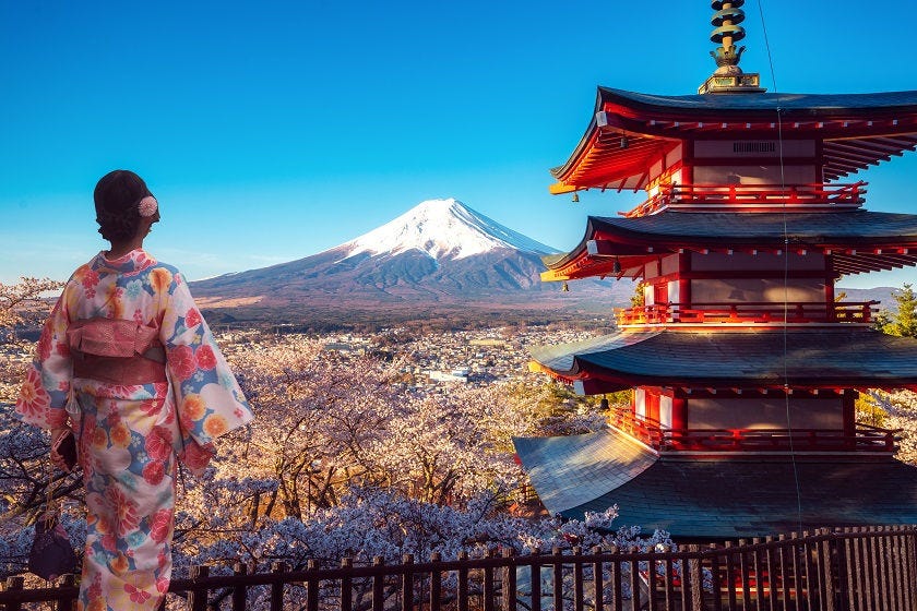 Japanese woman on balcony, looking at mountain in distance