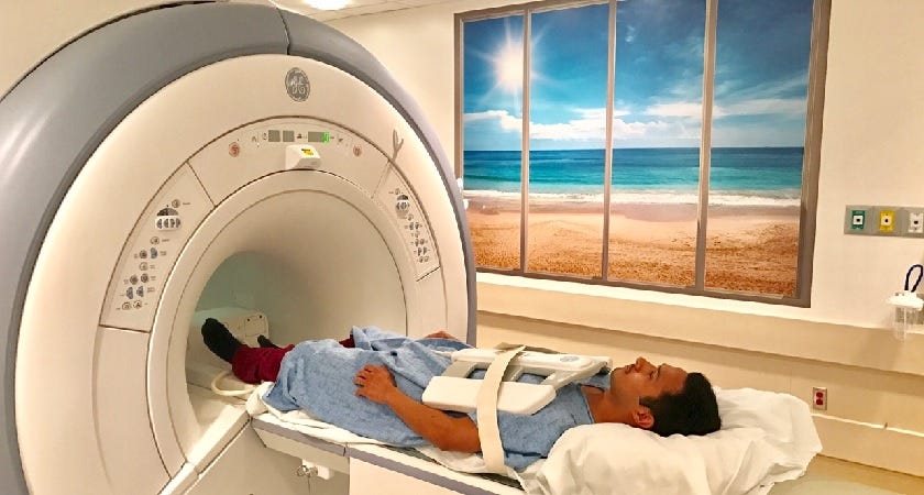 A person goes into an MRI scan machine