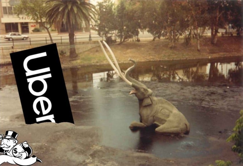 The sinking mammoth exhibition at the La Brea Tar Pits; next to the doomed pachyderm is the Uber logo, also mired in the tar. Monopoly’s Rich Uncle Pennybags is partially in the bottom left corner of the frame, running away with a bag of money. Image: Tarcil (modified) CC BY-SA: https://creativecommons.org/licenses/by-sa/4.0/deed.en