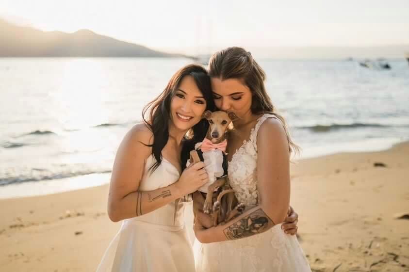 Lua with her wife and dog at their wedding