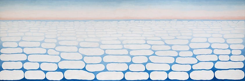 Georgia O’Keeffe painting of Sky Above Clouds IV. It’s a gradient of blue and pink with imperfect oval circles: clouds.