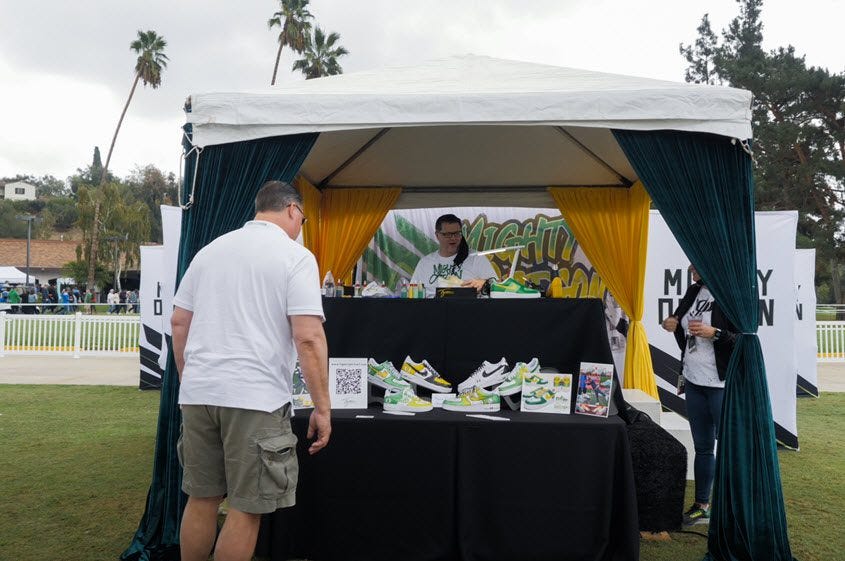 Event Activation at Tailgate Party. This station included a custom air brush artist who painted custom shoes for attendees in the school colors.