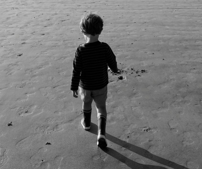 my four year old walking on the beach