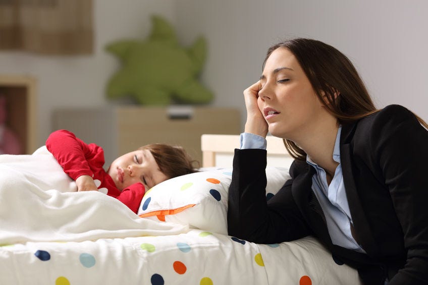 tired mom with sleeping child