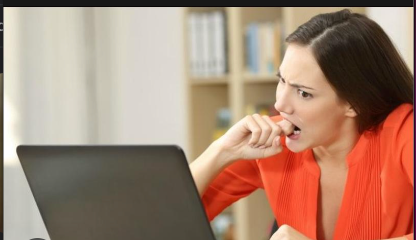 A woman looking at her computer screen with a jelouse expression