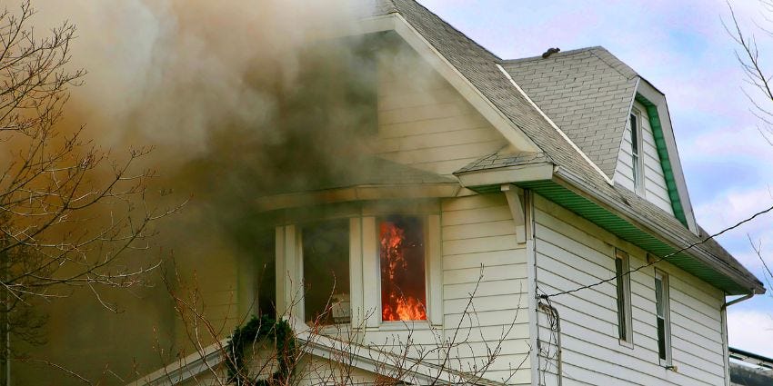 Pictured here is a home on fire with a holiday decorations hanging from the roof.