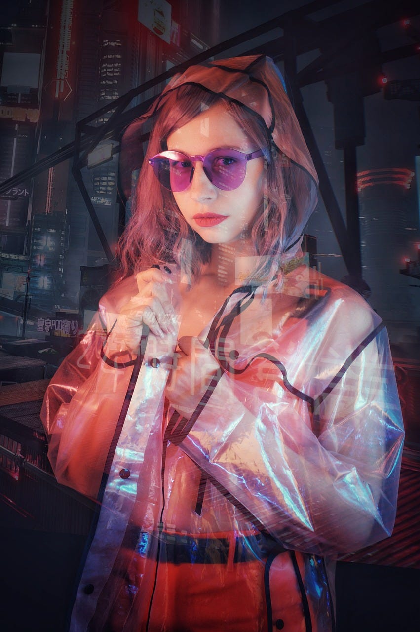 A woman wearing a Treansparent raincoat and sunglasses.