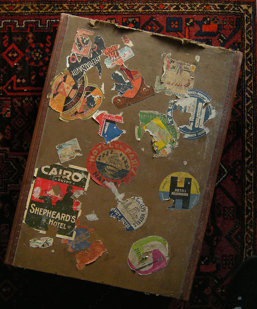 Photo of a old valise with stickers from different locations.
