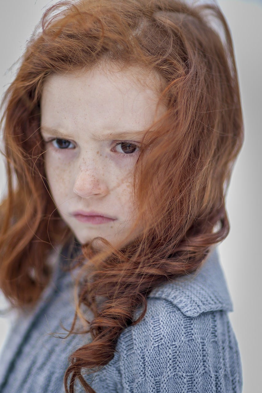 Female child with ginger hair and freckles