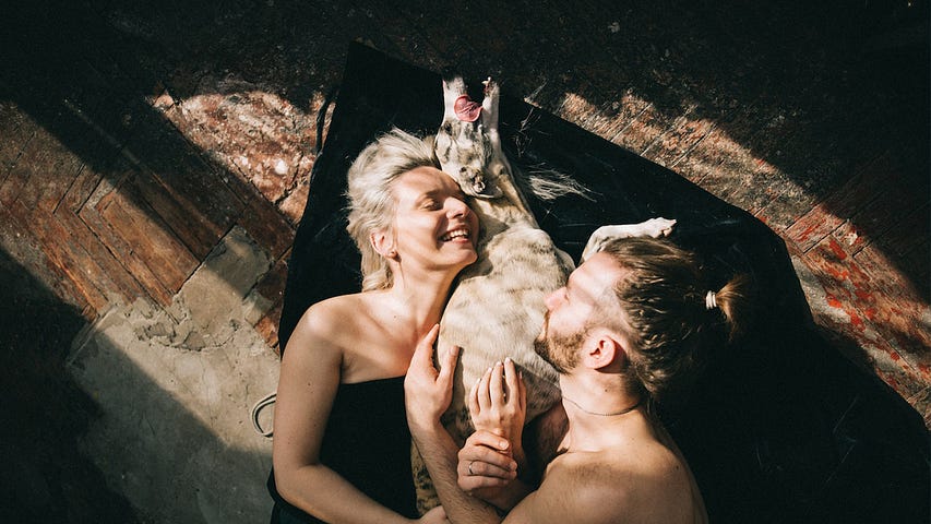 Couple with dog, laughing