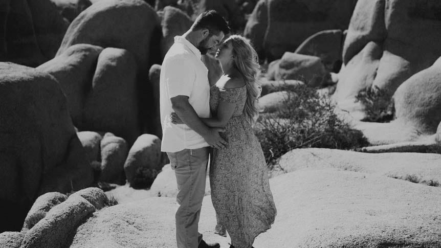 Young couple kissing in rocky desert