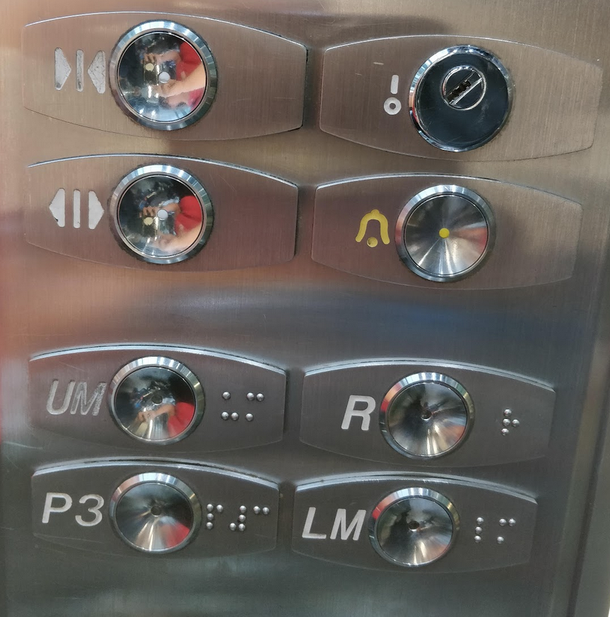 A photo of elevator/lift panel, with confusing button naming, as an example of poor UX design