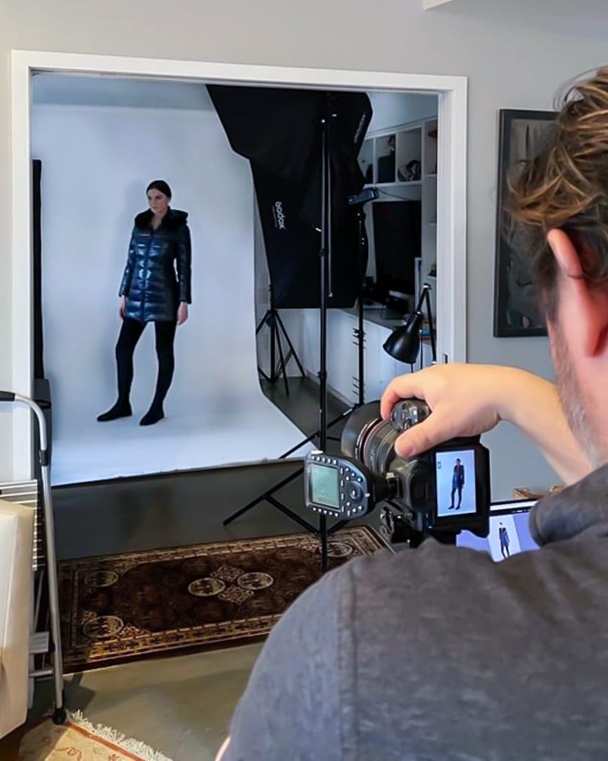 Photographer and model in action at a home photo studio shoot