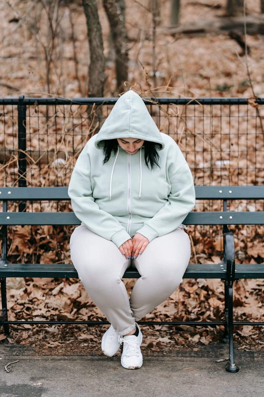 Photo by Andres Ayrton: https://www.pexels.com/photo/sad-woman-sitting-on-bench-in-autumn-park-6551488/