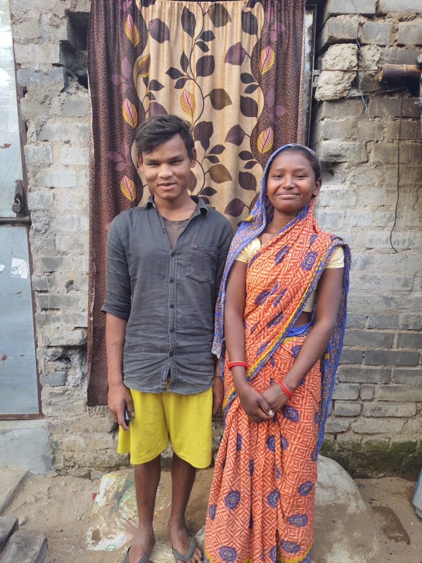 Muna and Puja in front of their house