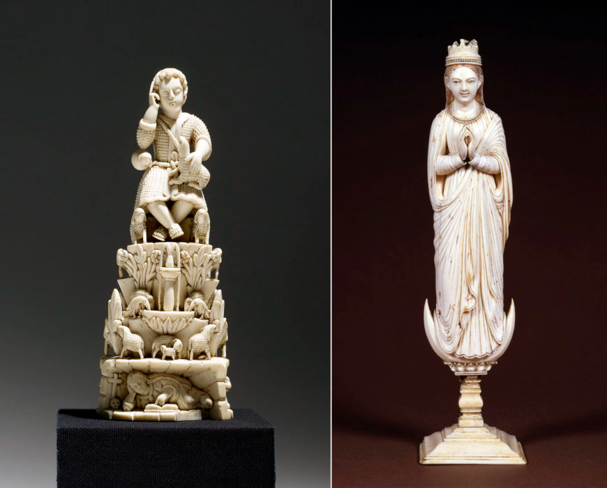 Two ivory sculptures: on the left, a detailed carving of a seated figure atop an elaborate tiered base featuring animals and floral motifs; on the right, a tall, elegant statue of a crowned female figure in a flowing robe with hands in a prayer gesture, standing on a pedestal.