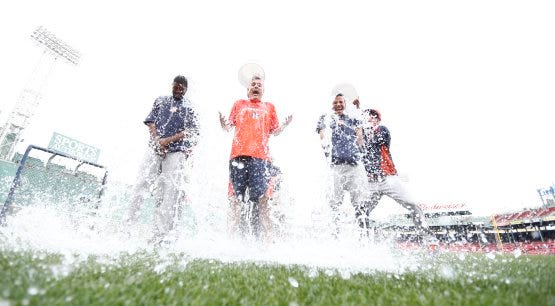 Fowler, Luhnow and Altuve accept the Ice Bucket Challenge at Fenway Park. (Photo credit: Mark L. Baer-USA TODAY Sports