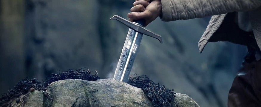 A hand pulling sword from the stone. Image from the internet for “Sword of Arthur” keywords.