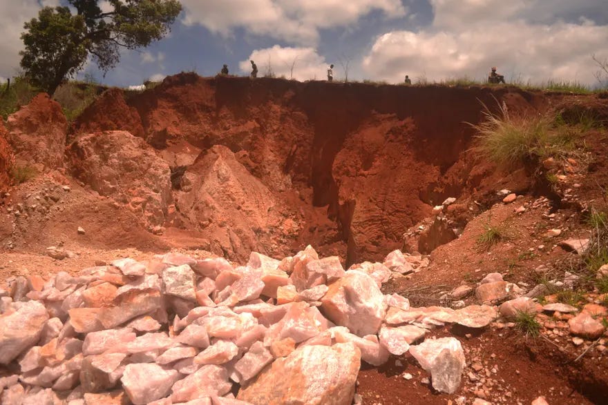 A quartz mine in Madagascar. In the distance, the silhouette of several miners can be seen.