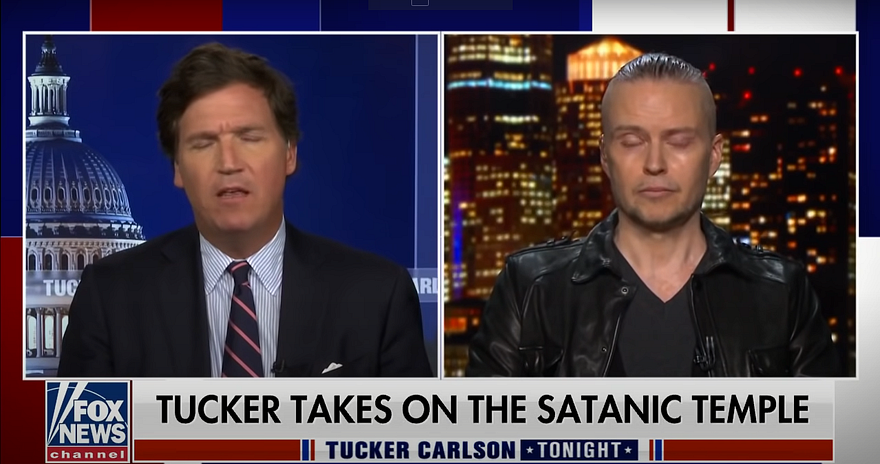 lucien greaves on tucker carlson tonight, chryon “tucker takes on The Satanic Temple” both men have eyes closed