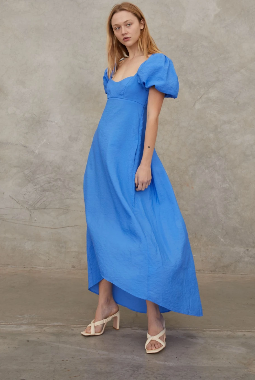 Women wearing a blue puff-sleeved dress