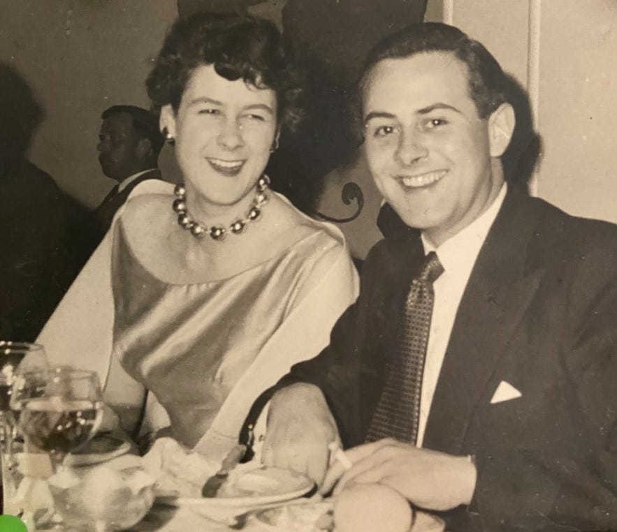 granny and frank smiling at the camera at a dinner party when they were much younger