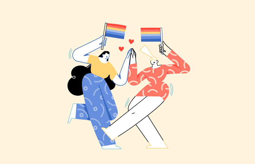 two people celebrate holding rainbow flags